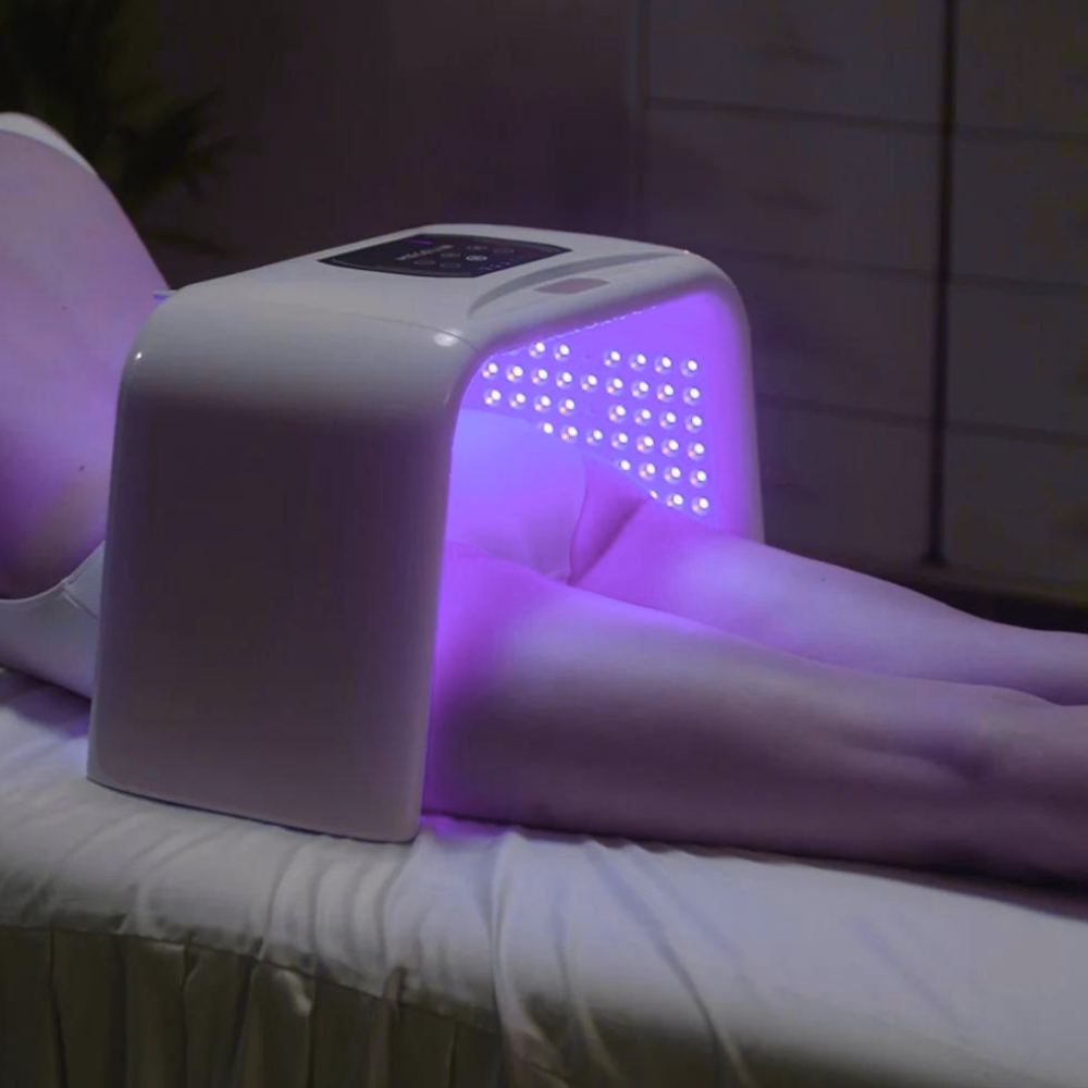 Infrared Knee Pad in use with purple light therapy, designed to reduce inflammation and promote joint recovery